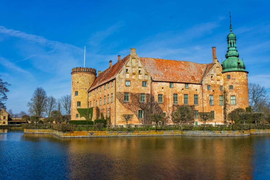 Beautiful view of historical Swedish castle surrounded by a calm moat in Skåne.