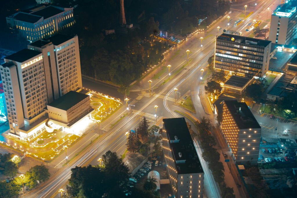 Stunning aerial view of Addis Ababa's illuminated cityscape at night, featuring modern buildings and lit streets.
